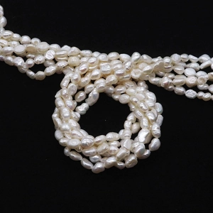 Macro view of lustrous white freshwater baroque pearls on a black background