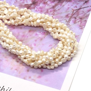 Handcrafted multi-strand necklace made of genuine white freshwater pearls in a soft oval shape