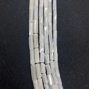 Natural white shell cylinder beads 5x10mm with iridescent luster on black background