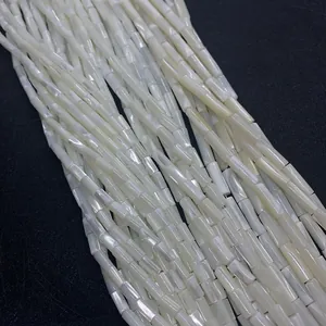 Macro shot of white cylindrical mother of pearl shell beads with iridescent luster for DIY