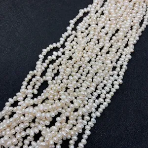 Macro shot of high-quality white natural freshwater rice pearls on a textured gray surface