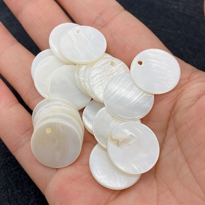 Vue macro de perles en nacre naturelle blanche 10mm avec trou pour bijoux DIY