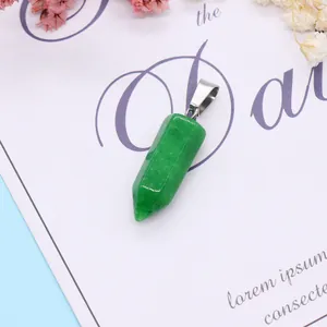 Detailed view of green stone hexagonal pendant with silver clasp on decorative background