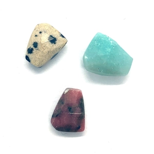 Close-up of faceted Dalmatian Jasper, Amazonite, and Rhodonite irregular stone beads