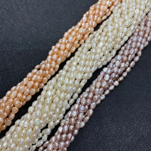 Macro detail of natural 5-6mm rice-shaped freshwater pearls in multiple colors