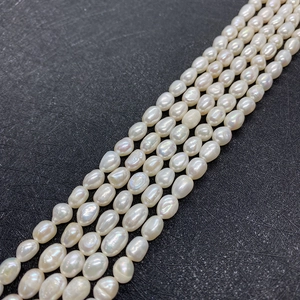 Detailed macro view of natural white freshwater oval pearls with high luster and iris fire