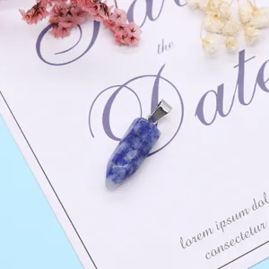 Hexagonal blue marble natural stone pendant with silver metal clasp on artistic paper
