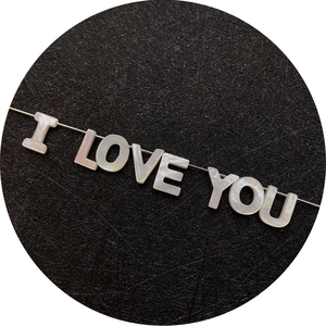 Iridescent white shell beads spelling I LOVE YOU on a delicate silver metallic wire