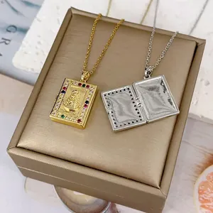 Detailed view of book-shaped Virgin Mary locket necklaces with colorful zircon inlay