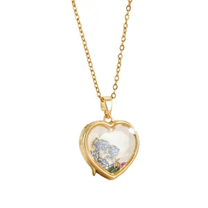 Vintage 18k gold heart locket necklace with colorful crystals in a hollow glass pendant