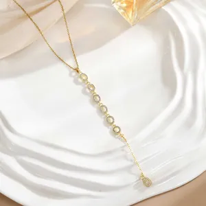 Detail of a gold Y-shaped tassel necklace with micro-pave cubic zirconia accents