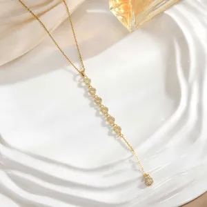 Elegant gold long tassel necklace featuring sun star moon zircon pendants on a silk background