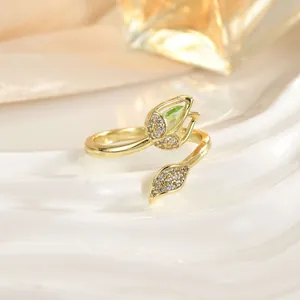 Detailed view of tulip open ring with green stone and micro-paved zircons on ceramic base
