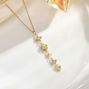 Detailed shot of gold tassel necklace featuring star, moon, and butterfly cubic zirconia pendants