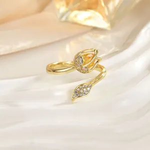 Close-up of golden tulip ring with yellow teardrop gemstone and white zircon petals