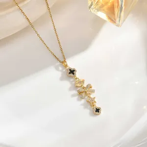 Long tassel necklace with sun, moon, and star charms featuring micro-set zircon details