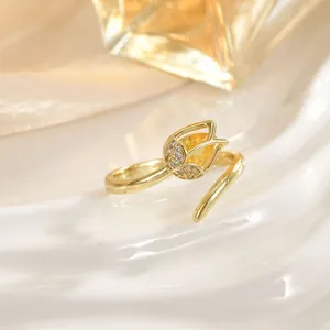 Close-up of golden tulip ring with yellow teardrop stone and sparkling crystal accents