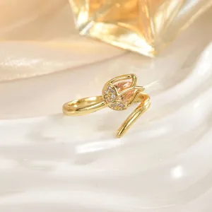 Macro shot of a gold tulip ring featuring champagne stones and sparkling zircon details