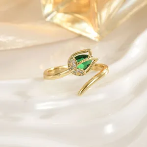 Macro detail of tulip flower ring with green stone and gold-plated adjustable band