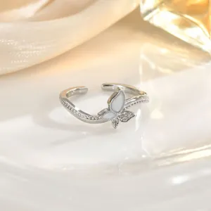 Detail view of silver butterfly ring with white enamel and micro-set zircon accents