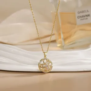 Detailed close-up of a rotating flower pendant on a gold titanium steel necklace