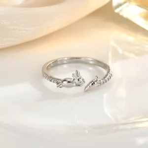 Detail view of adjustable silver ring with rabbit and carrot charms and pavé zircon stones