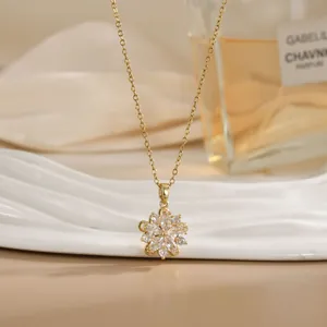 Detailed view of a rotating flower pendant necklace with white zircons on beige silk