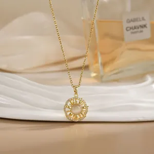 Close-up of golden sun pendant necklace with opal center and diamonds on silk