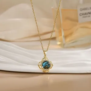 Macro detail of rotating flower pendant with blue celestial stone and zircon accents