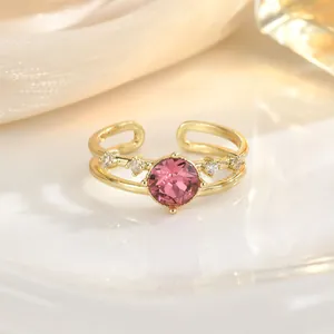 Detailed close-up of a pink gemstone heart ring with gold band and small diamond accents