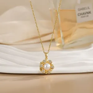 Detailed view of a rotatable gold flower necklace with a pearl center and zircon inlay