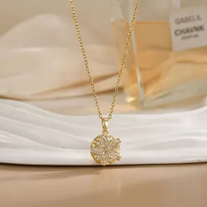 Close-up of golden spinning flower necklace with marquise crystals on a ceramic plate