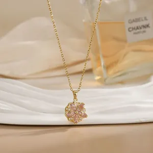 Detail of a rotating flower necklace with pink marquise gems and gold titanium steel