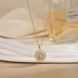 Detail shot of a rotating golden flower necklace with sparkling zircon pendant