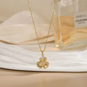 Detailed close-up of a rotating golden flower pendant with sparkling zircon stones