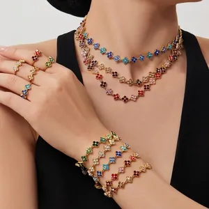 Colorful zircon four-leaf clover jewelry set with gold necklace, bracelets, and rings