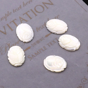 Macro view of white carved shell rose beads with iridescent mother of pearl finish