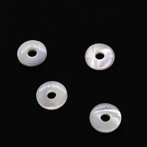 Vue détaillée de quatre pendentifs anneaux en nacre naturelle avec un éclat perlé doux