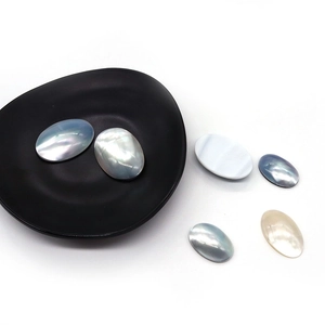 Macro detail of natural oval iridescent shell cabochons for jewelry making and DIY crafts