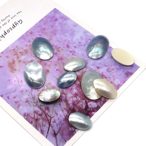 Macro shot of oval natural mother of pearl shell cabochons with iridescent luster