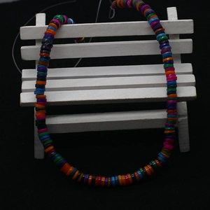 Bohemian style colorful disc beads necklace made of dyed freshwater shell on white stand
