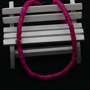 Detail of rose red Heishi flat disc shell beads for DIY jewelry making and clothing crafts