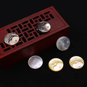 Engraved round moon face sea shell pendants in black, white, and golden pearl finishes