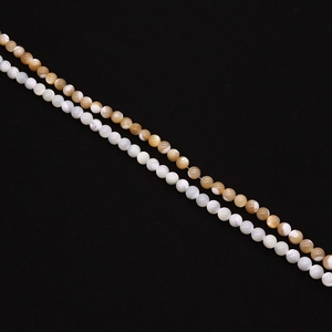Detailed macro view of natural white and honey-colored shell beads in parallel layout