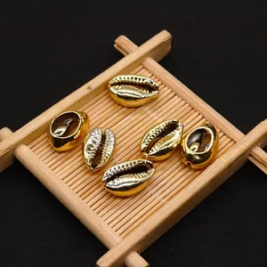 Detailed close-up of six gold-plated conch shell beads for DIY jewelry making