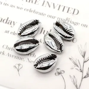 Detail view of five silver-plated conch shell beads with metallic texture for jewelry making