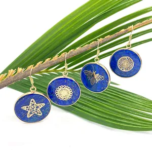Lapis lazuli round earrings with gold sea star and mandala patterns on palm leaf