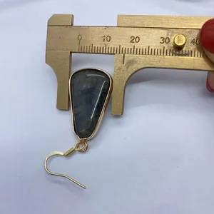Detail showing measurement of 14mm natural stone drop earring using a brass caliper