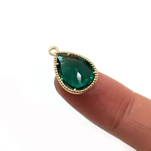 Emerald green faceted teardrop crystal pendant in a gold-plated beaded pave setting