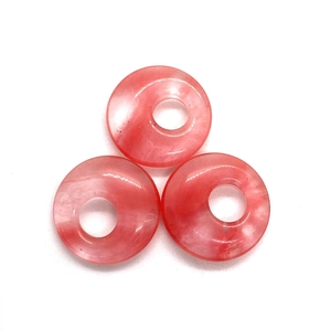 Three translucent pink strawberry quartz donut charms with natural textures for jewelry making